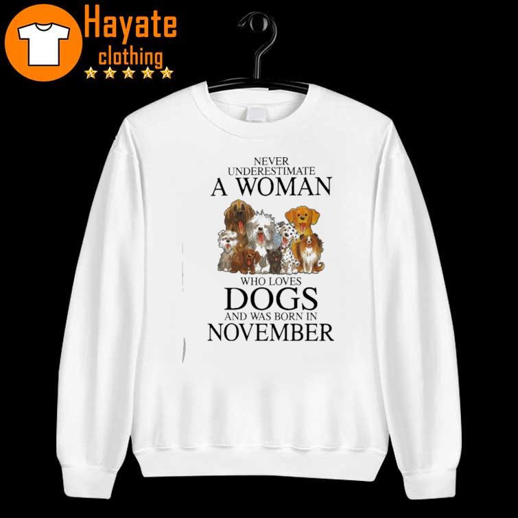 Never underestimate a Woman who loves Dogs and was born in November sweater
